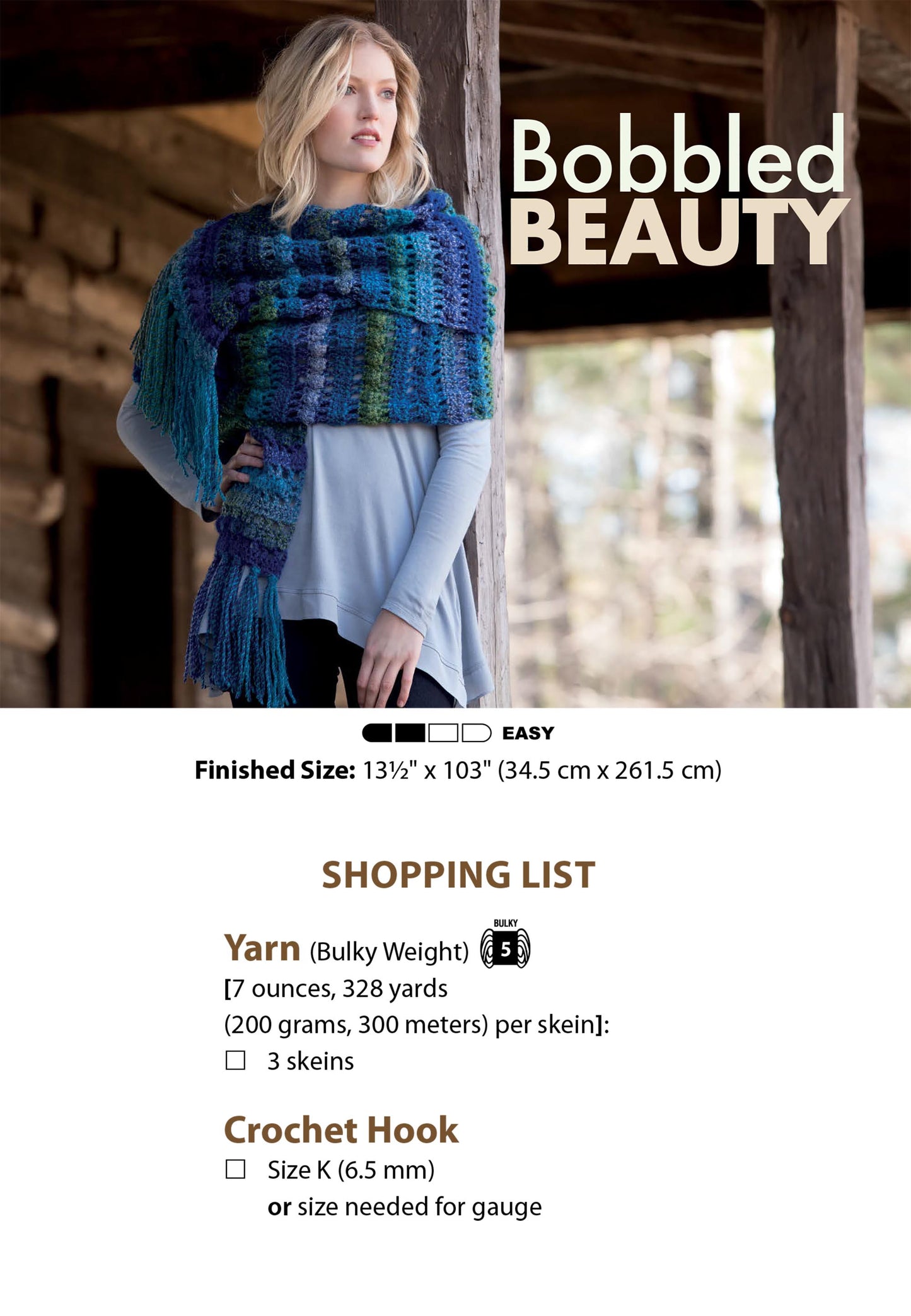 A woman stands on a porch wearing a chunky blue, teal, and purple crocheted scarf with fringe. Text overlay shows “Textured Super Scarves Crochet” by Leisure Arts—beginner-friendly pattern with yarn and hook info for unique crochet lovers.