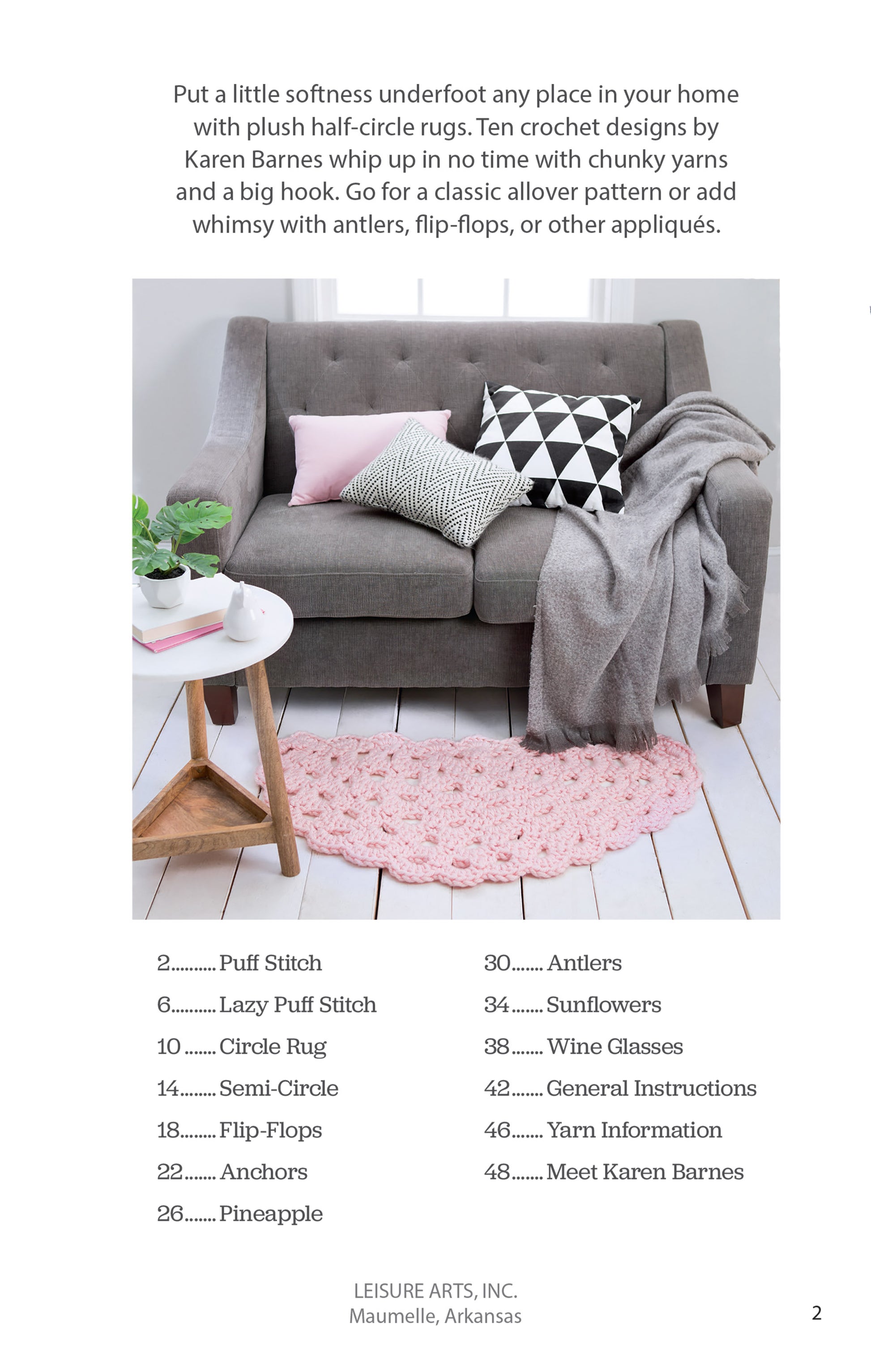A modern living room features a gray sofa, black-and-white geometric pillows, a white throw, and a pink Leisure Arts Half Moon Rug on a white floor. A wooden stool with a mug and book sits beside the sofa. Beginner crochet patterns are listed below.
