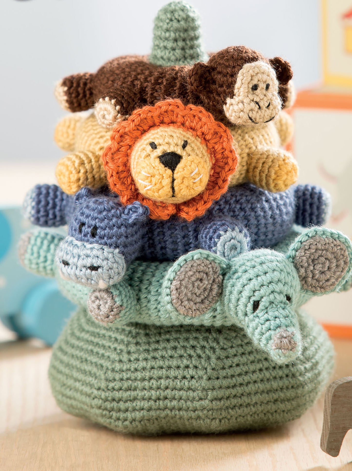 Baby Stacks—6 Easy Toys to Crochet! by Leisure Arts features soft, stackable animal rings—monkey, lion, hippo, and elephant on a green base. Perfect for fans of baby crochet toys and fun crochet patterns.