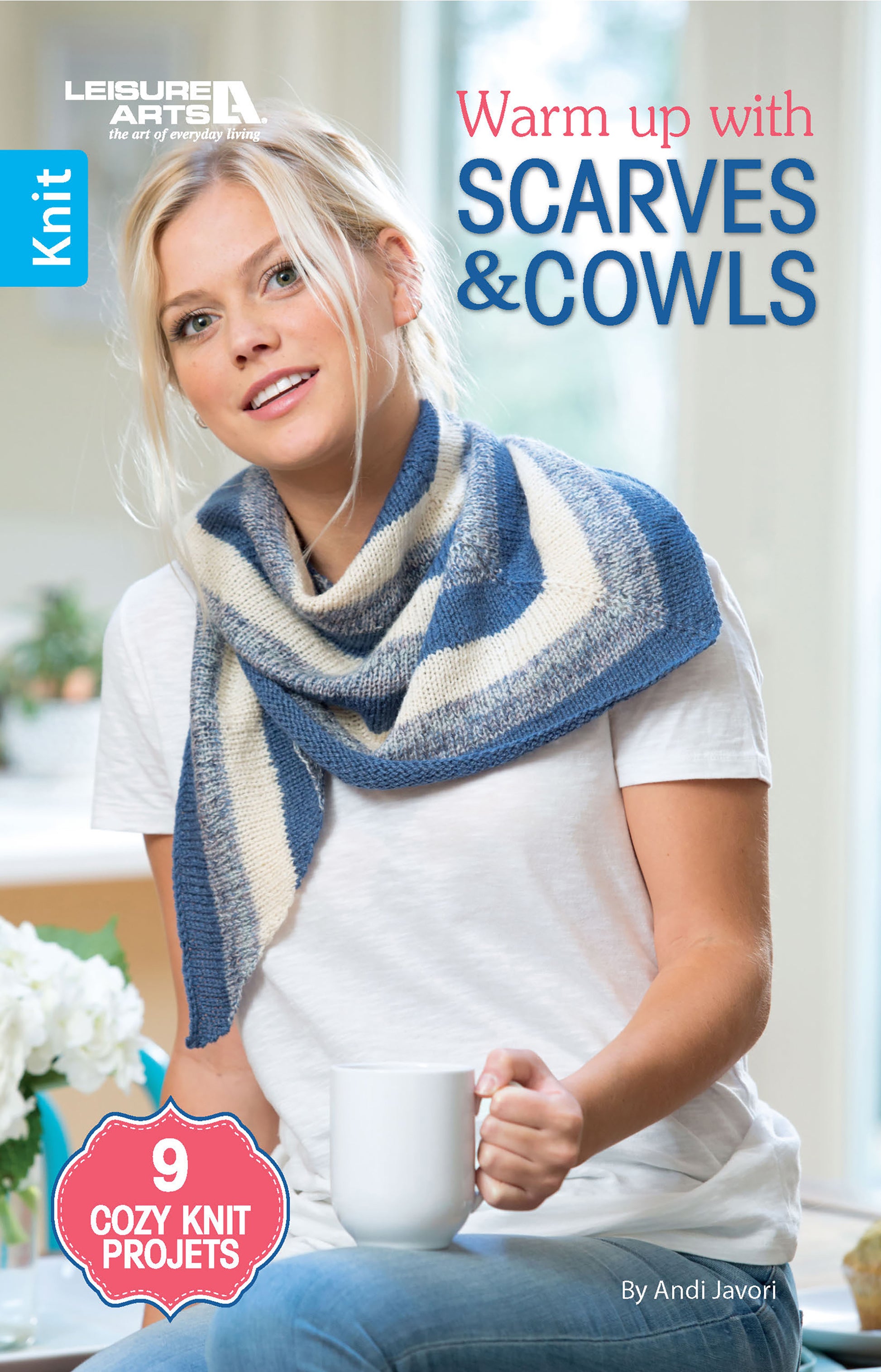 A blonde woman wears a blue and white knit scarf, sits on a couch with a white mug. Text: Warm up with Scarves & Cowls by Leisure Arts—9 cozy projects featuring beginner cowl ideas and stylish scarf patterns.