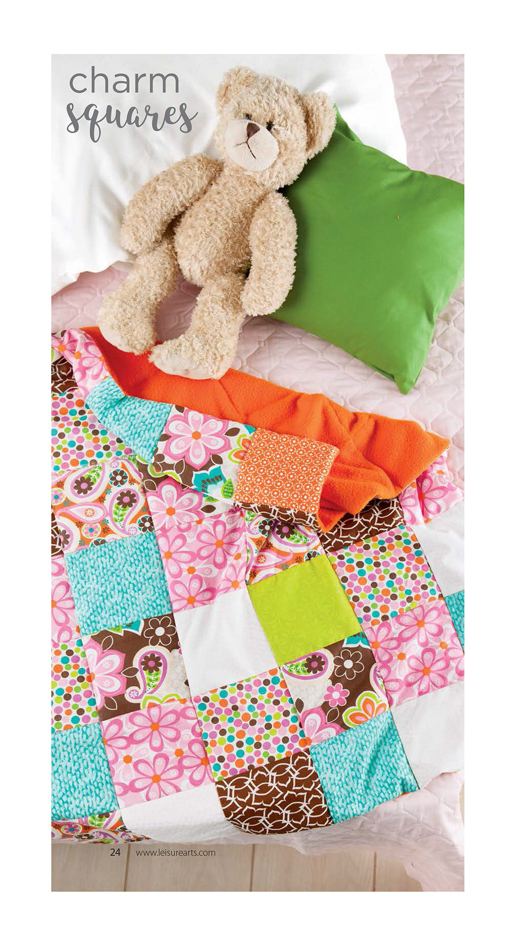 A Leisure Arts Cozy Weighted Blanket with colorful floral and geometric squares is spread on the bed, offering calming comfort, with a green pillow and a beige teddy bear resting on top.