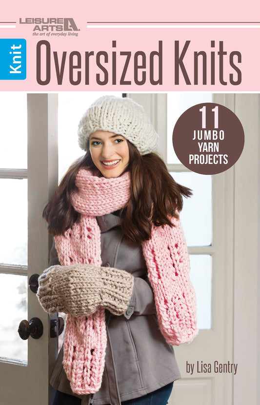 The book cover of "Oversized Knits" by Leisure Arts shows a smiling woman in chunky knit accessories. The text highlights 11 jumbo yarn projects with easy knitting patterns.