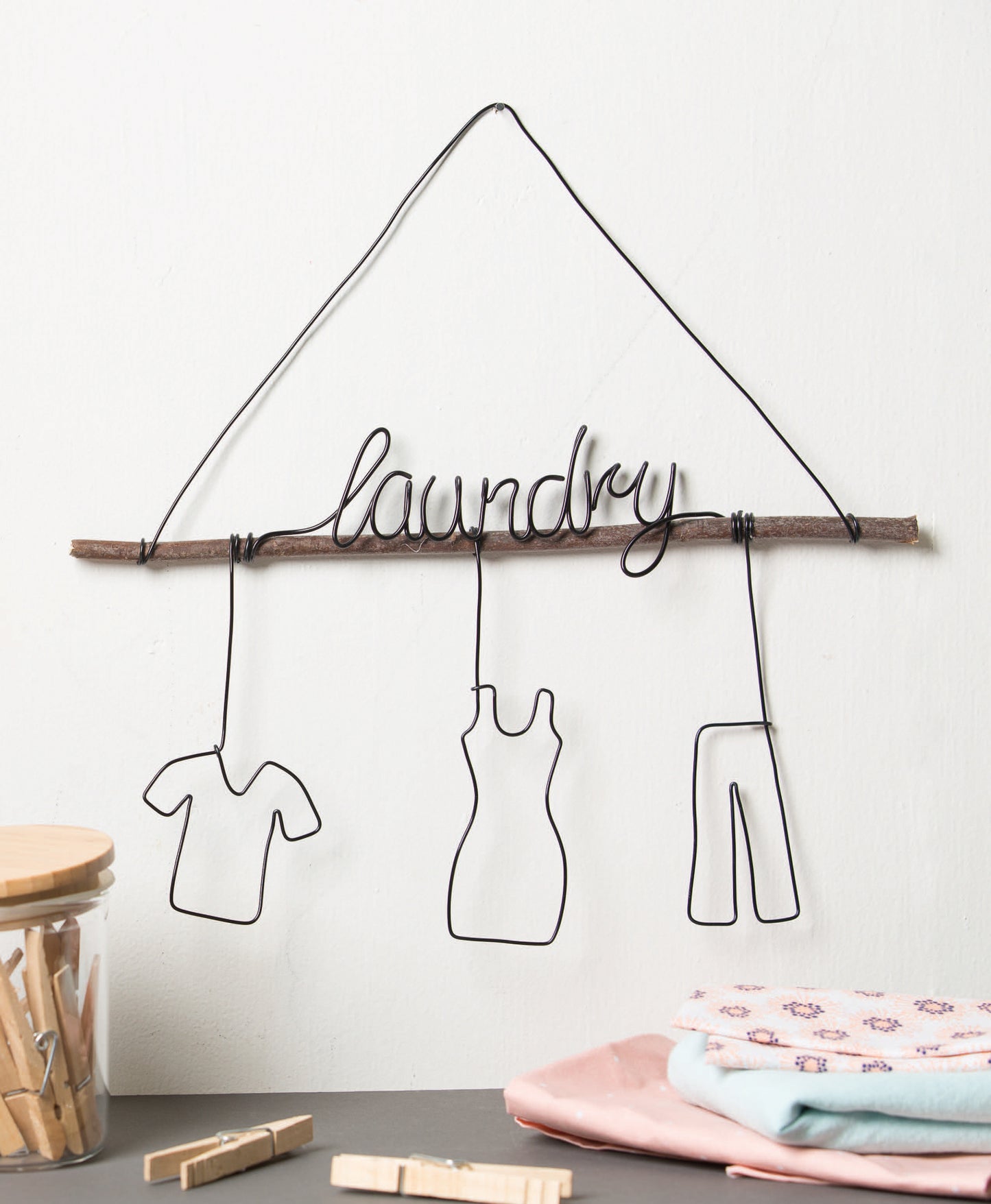 Inspired by "Wire Crafts—18 Wire Wrapping Projects to Bend, Wrap and Twist" from Leisure Arts, this Laundry wire hanger with shirt, dress, and pants outlines is perfect for beginner home decor or creative wire wrapping ideas.