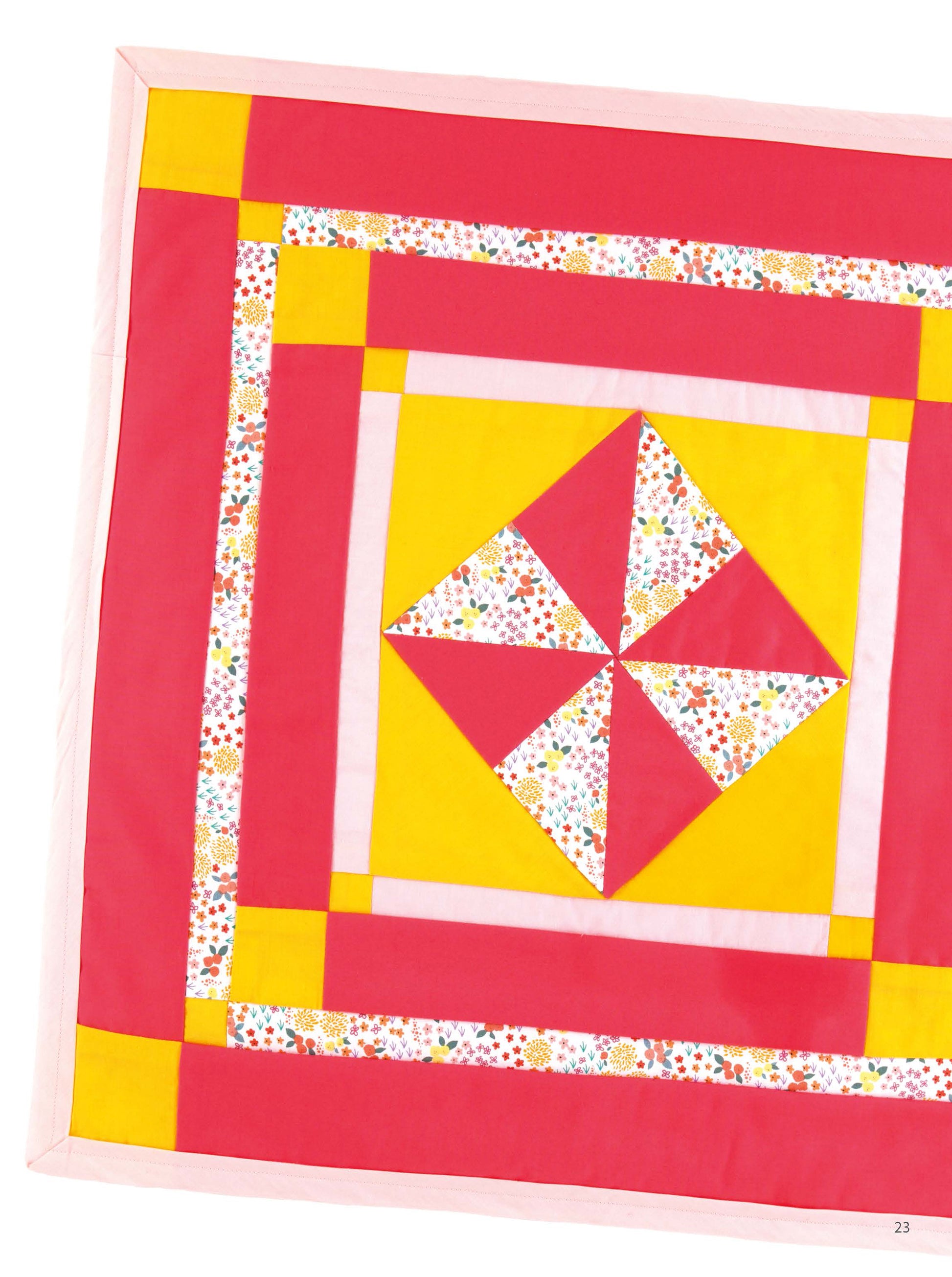 From Leisure Arts’ “Miniature Quilts—12 Tiny Projects That Make a Big Impression,” this mini quilt showcases a vibrant pinwheel with red, yellow, and floral triangles plus bright borders—an ideal home decor gift. Only part of the quilt is shown.
