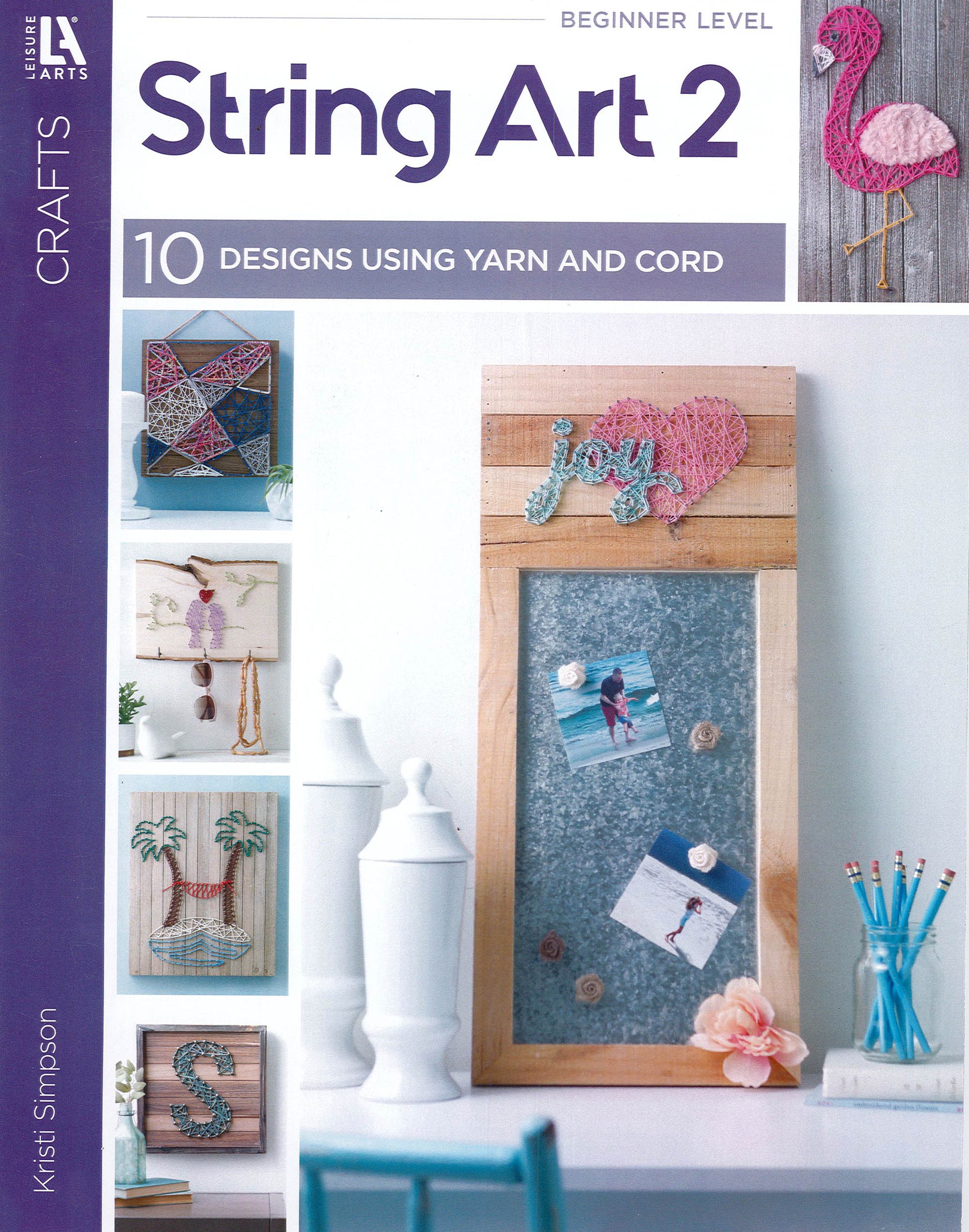 The Leisure Arts String Art 2 book cover showcases beginner-friendly string art designs like a flamingo, geometric heart, "joy," ballerina, palm tree, and letter S on wood plaques—ideal inspiration for yarn and cord projects.