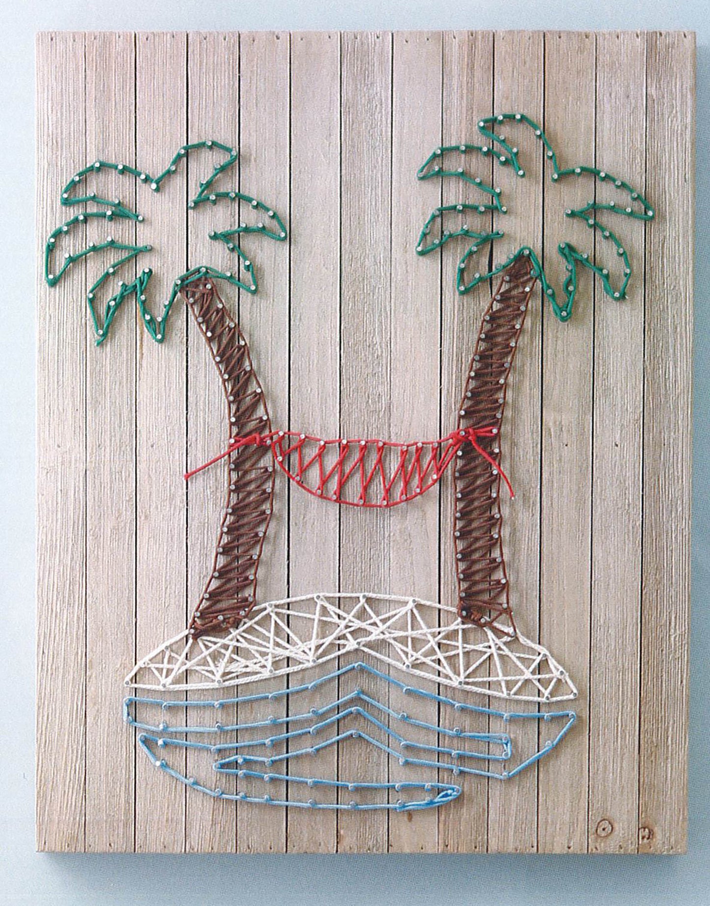 String Art 2 by Leisure Arts features two palm trees with green leaves, a red hammock, a white island, and blue water lines—ideal beginner string art for peg board home decor or creative yarn and cord projects.