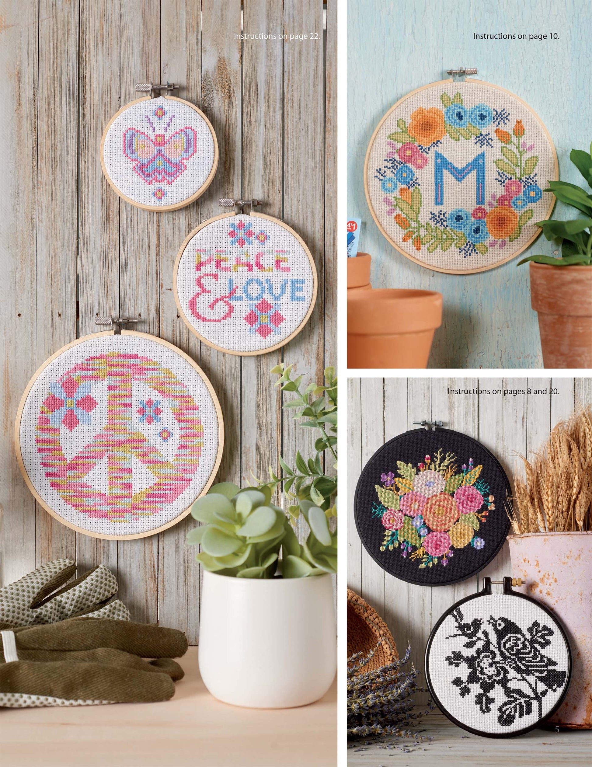 Leisure Arts' “From the Garden Cross Stitch” embroidery hoops showcase vibrant designs—like hearts, “Peace & Love,” floral letter “M,” and more—ideal for home decor or fashion accessories, all beautifully arranged on wooden surfaces.