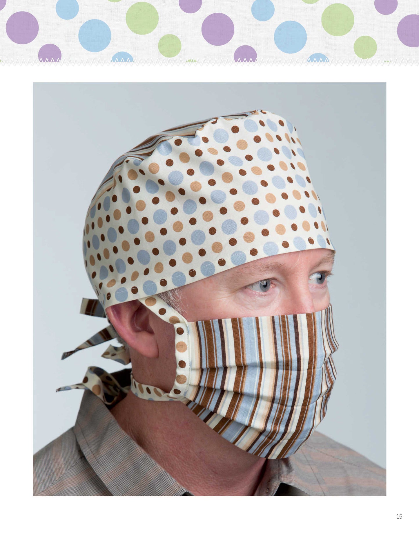 A person in a plaid shirt wears a matching cap with brown and gray polka dots and a striped face mask, made from the "Breathe Easy—8 Simple Sew and Applique Particle Mask and Cap Projects" by Leisure Arts. They are facing slightly to the right.