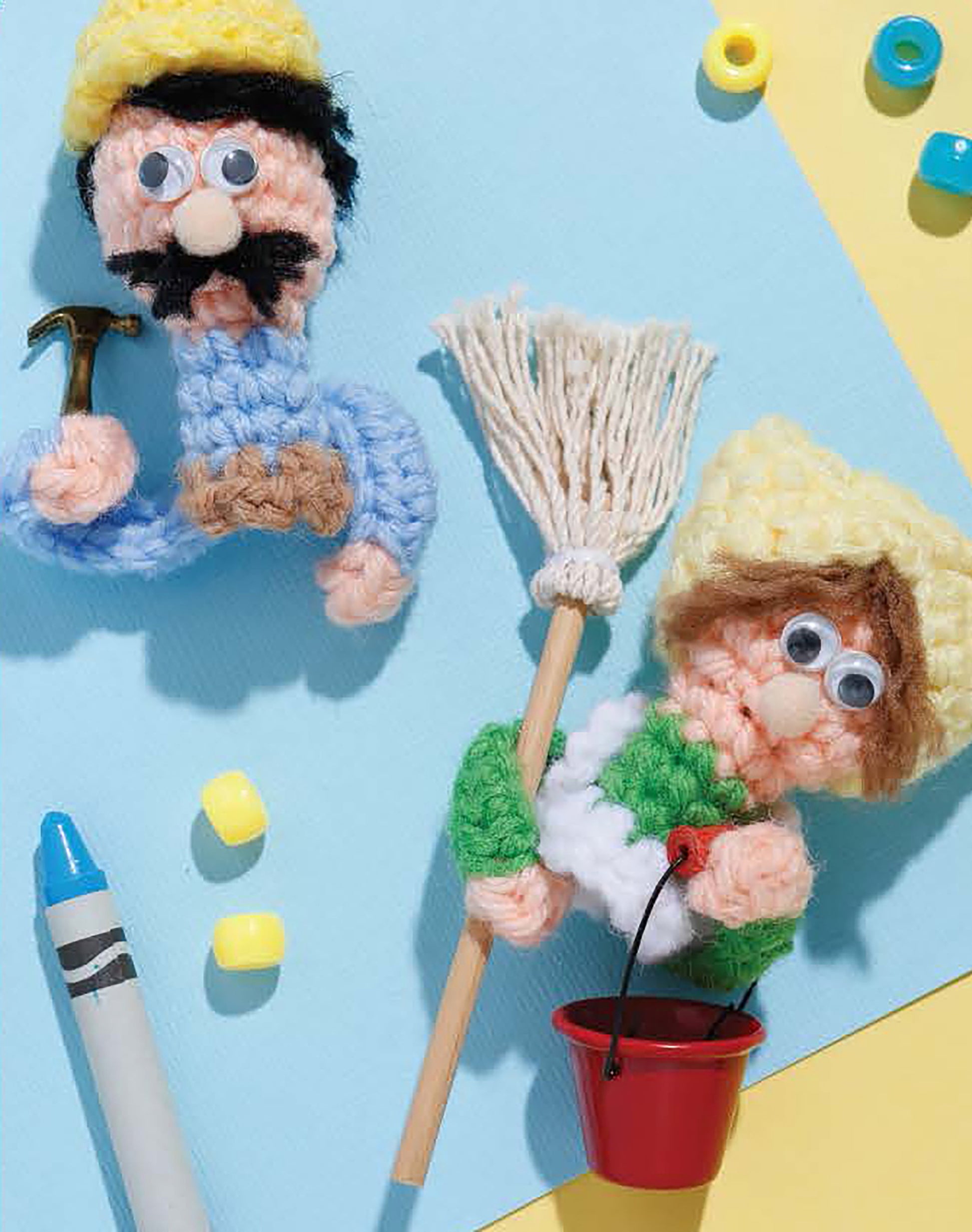 Leisure Arts’ Finger Puppets Our Town set features two crochet puppets with googly eyes: one in blue holding a hammer, the other in green and white with a mop and red bucket. Includes yellow beads and a blue crayon. Great for career play!.