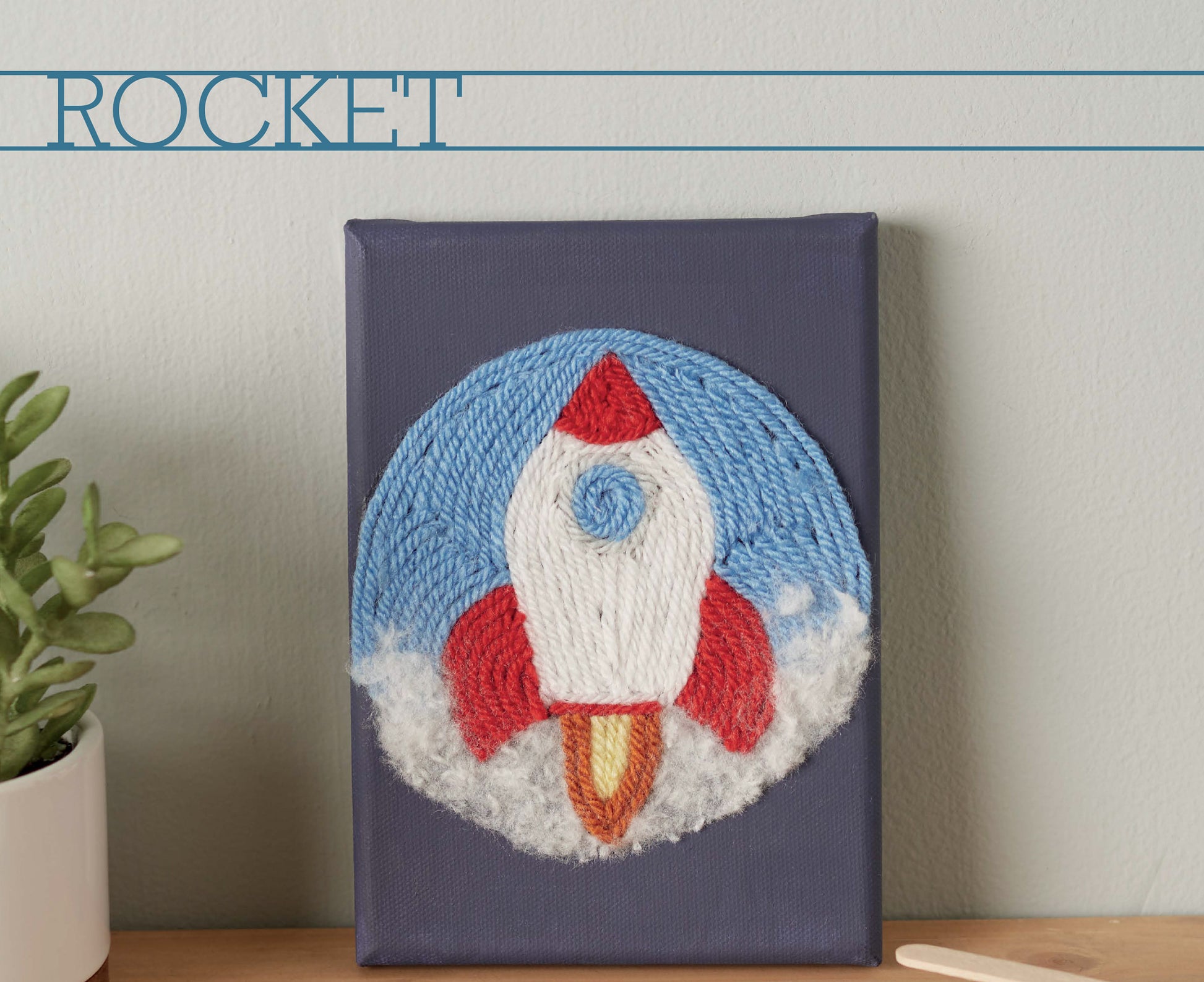 Leisure Arts Yarn Painting Digital Download: Create a red and white rocket with blue and white yarn sky on canvas. Features "ROCKET" above the design. Great for creative canvas crafts or beginner projects. Display next to a favorite potted plant!.
