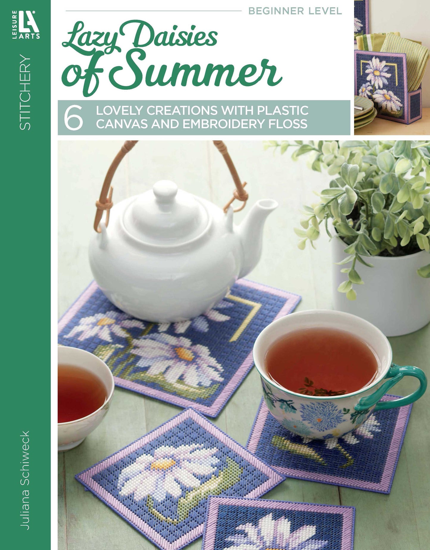 A teapot and two cups of tea rest on blue and purple Lazy Daisies of Summer coasters from Leisure Arts—ideal for beginner home decor or embroidery floss crafts, with more embroidered daisies nearby creating a relaxed, summery vibe.