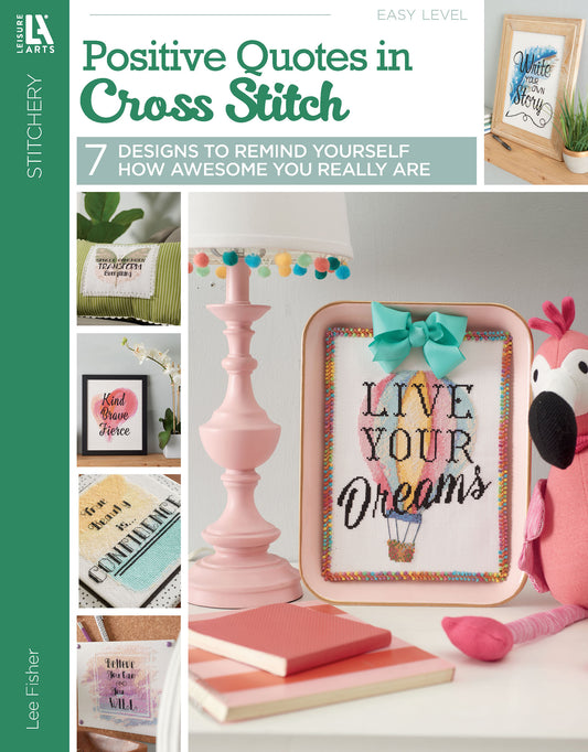 Cover of Positive Quotes in Cross Stitch Digital Download by Leisure Arts, featuring 7 colorful quote designs, decorative accents, and a flamingo plush. Main design reads "Live Your Dreams"—ideal for beginners.