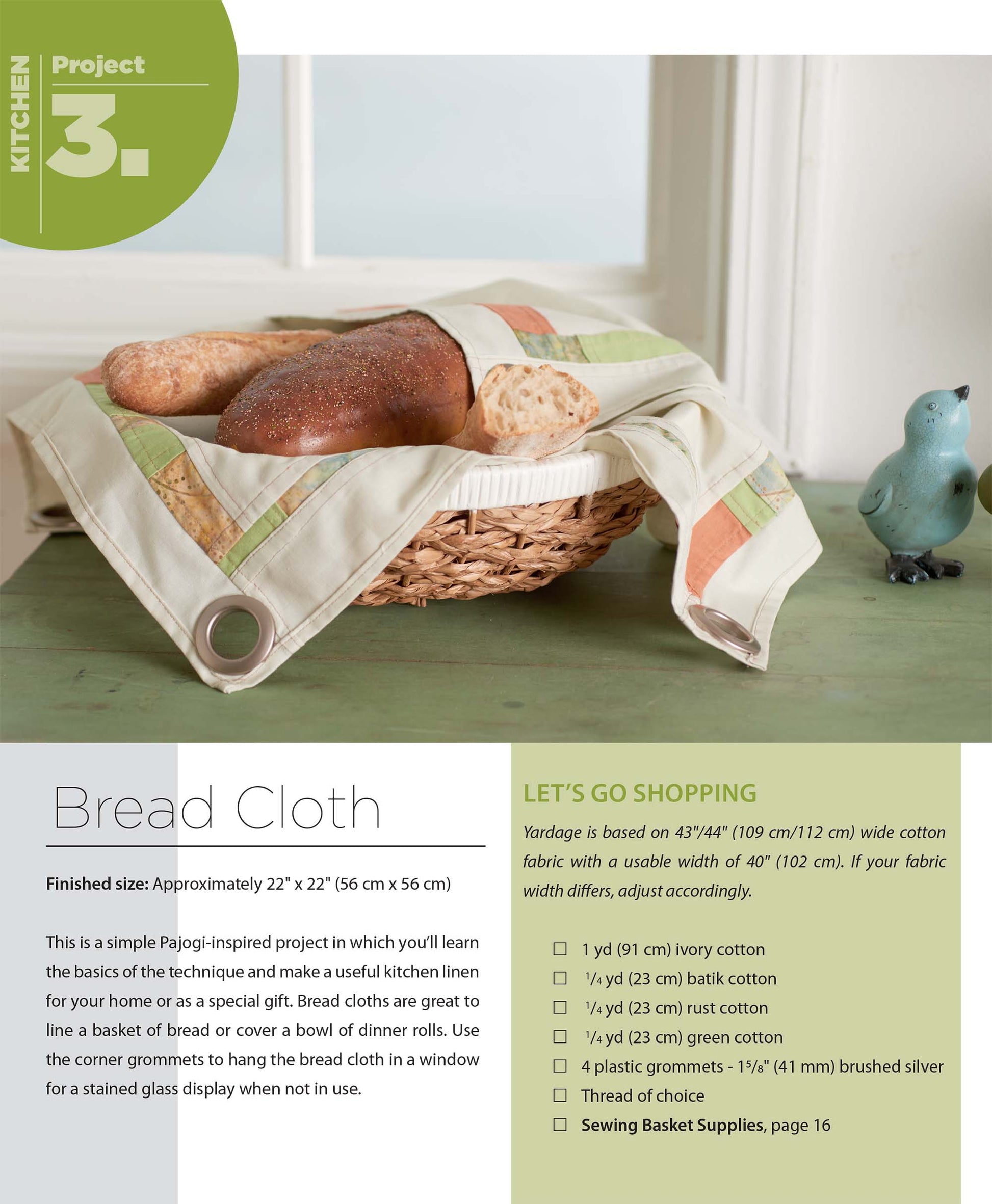 A basket lined with a Pajogi-Style Patchworks cloth from Leisure Arts holds bread, while a green ceramic bird and stacked plates rest on the table. Text highlights this charming Korean patchwork sewing project for your kitchen.