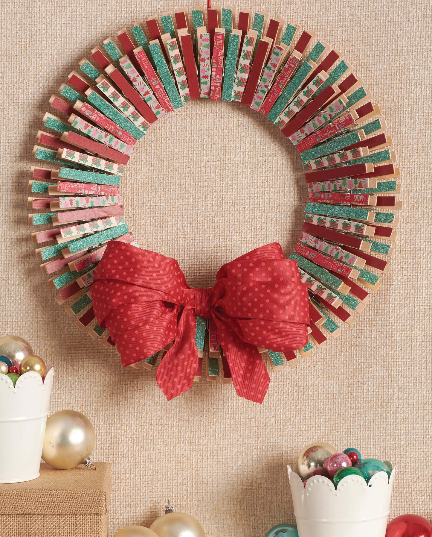 The Leisure Arts Clothespin Wreaths feature green and red decorated clothespins arranged in a circle with a red bow—ideal for festive home decor and Christmas craft projects.