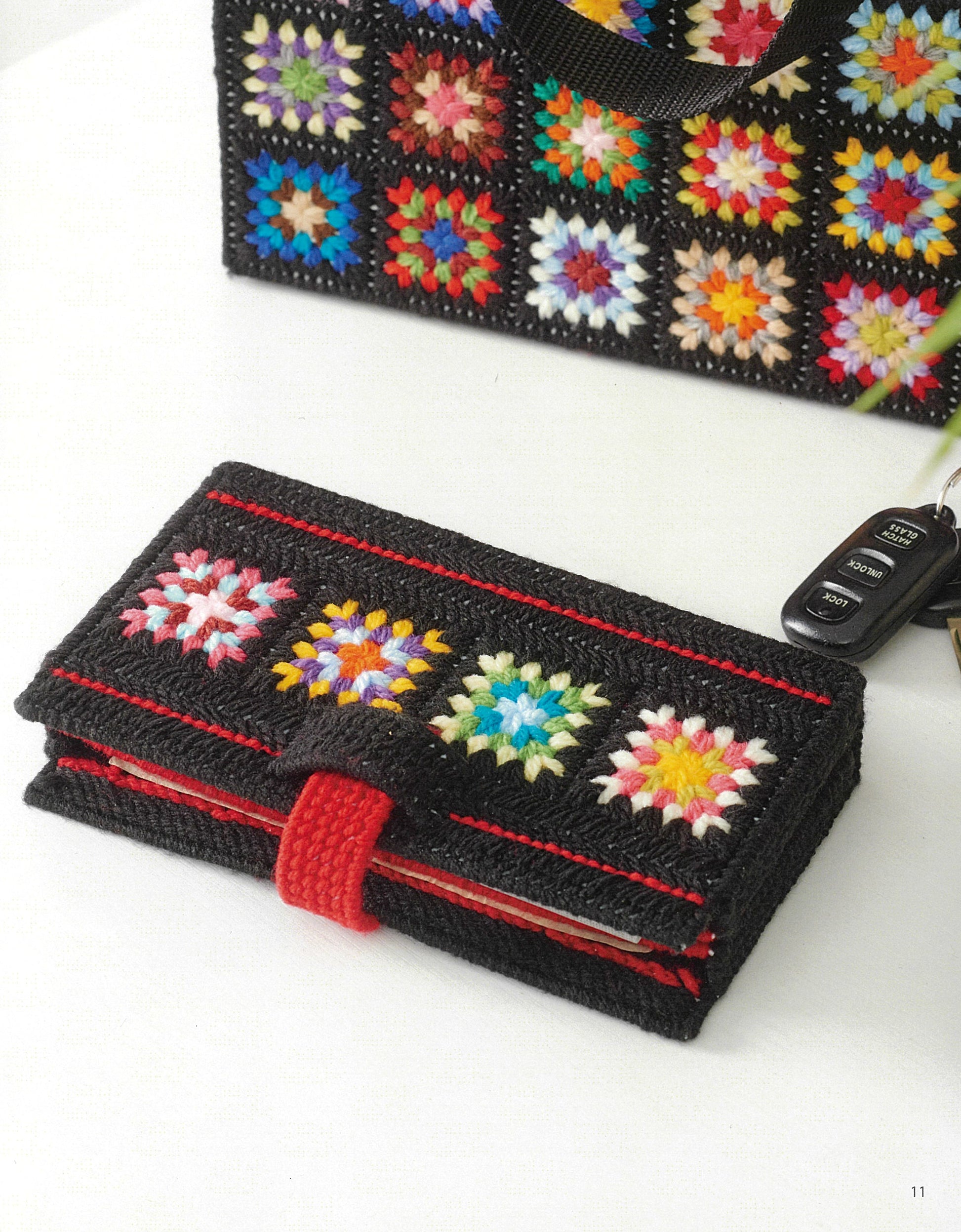 The Leisure Arts Granny Square Tote & Wallet Digital Download displays a black crochet wallet with colorful granny squares and a matching retro bag on a white surface, with car keys placed nearby.