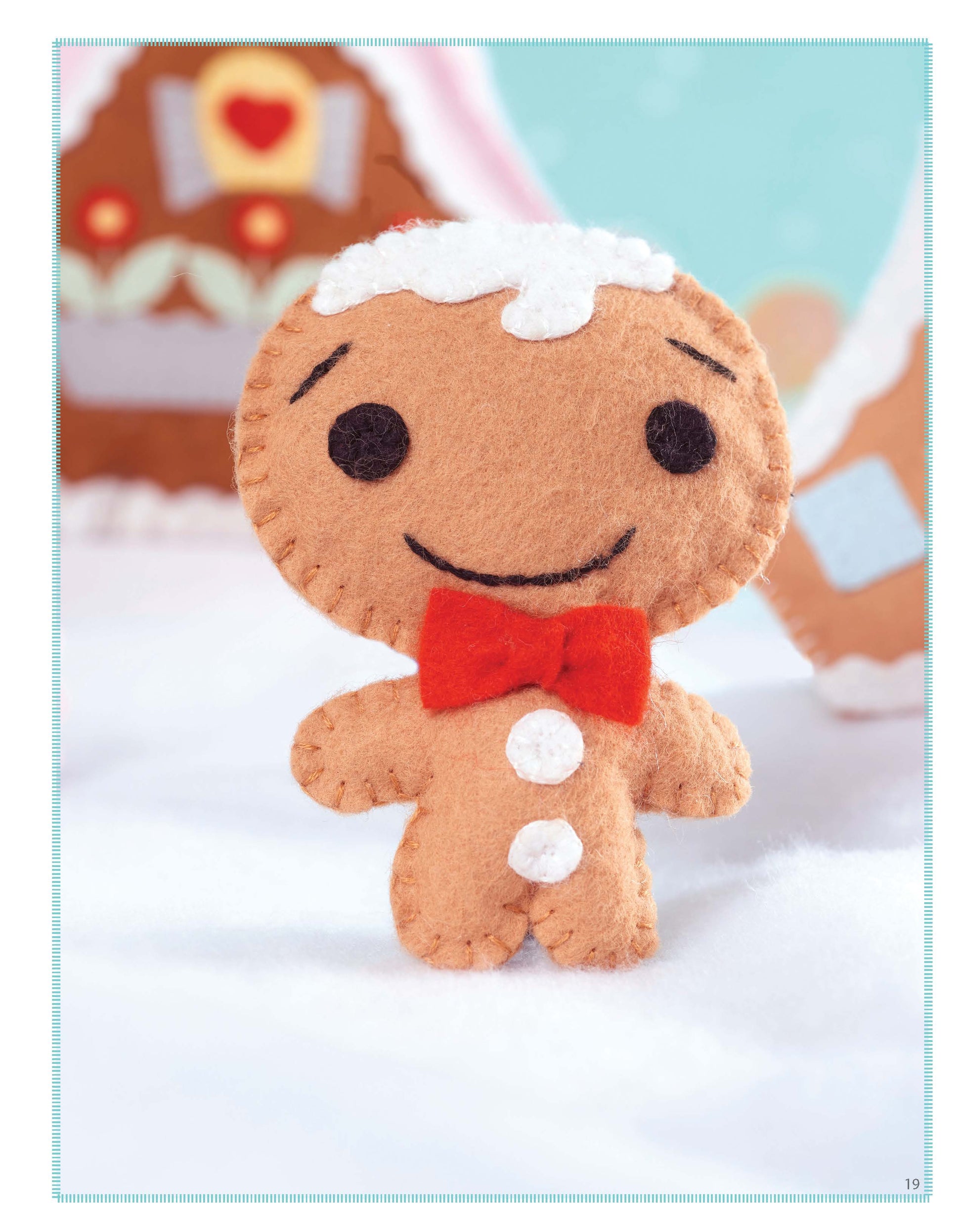 The Leisure Arts Gingerbread House features a felt gingerbread man with stitched details, a red bow tie, and white buttons—ideal for beginner embroidery inspiration or creating cute felt gingerbread ornaments.