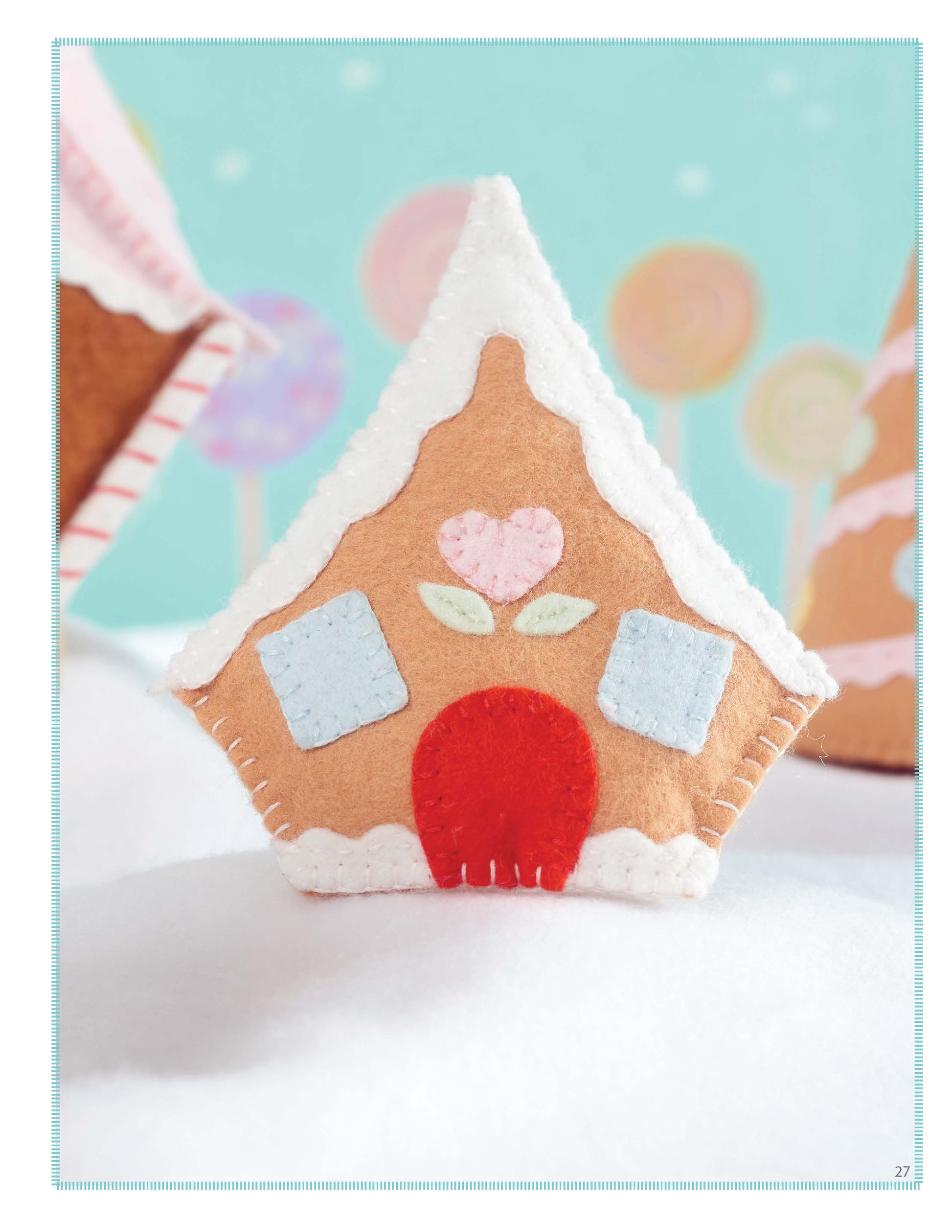 The Leisure Arts Gingerbread House is a soft felt design with a red door, blue windows, and cute heart and leaf accents—ideal for inspiring wool felt projects or charming holiday gingerbread ornaments.