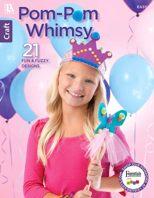 A smiling girl in a pink shirt holds a butterfly wand crafted from chenille stems and wears a playful pom-pom crown, with blue and purple balloons in the background. Text: Pom-Pom Whimsy by Leisure Arts—21 Fun & Fuzzy Designs for beginners, featuring delightful felt craft projects.