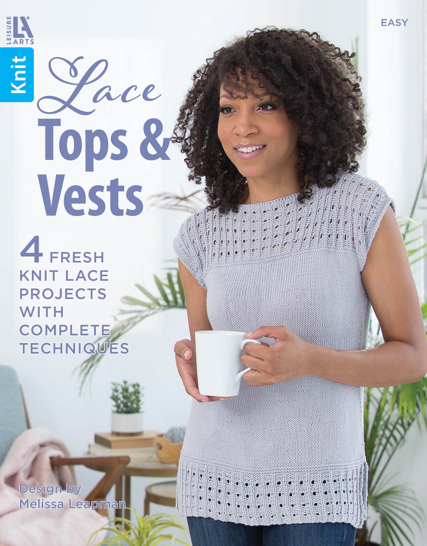 A smiling woman in a light gray lace top holds a white mug. Cover: Lace Tops & Vests by Leisure Arts—4 fresh patterns with full techniques by Melissa Leapman. Easy skill level, perfect for beginner knitting collections.