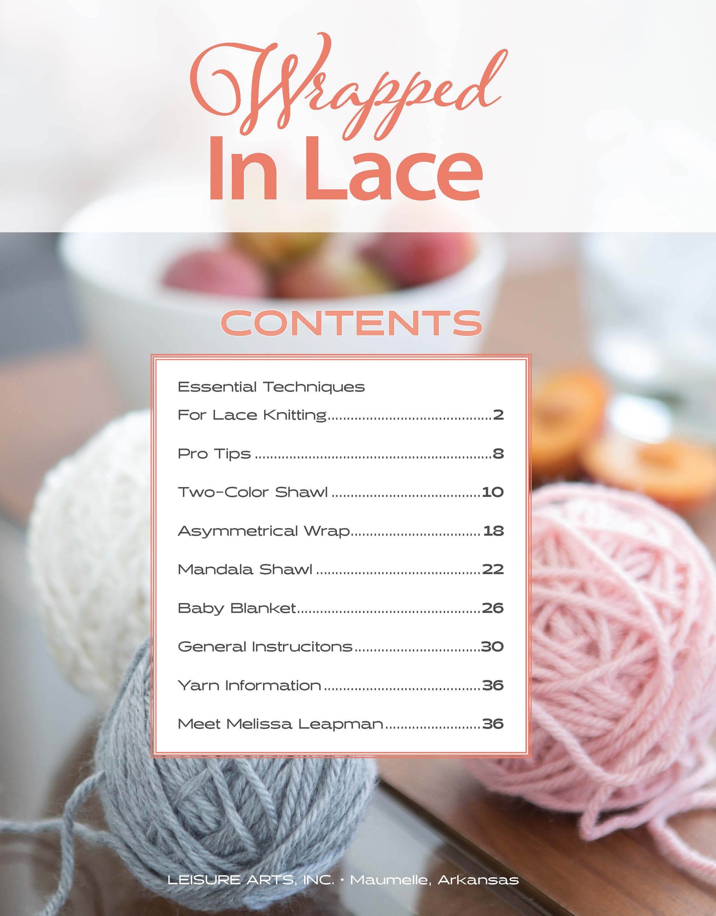 The Wrapped in Lace table of contents by Leisure Arts lists lace knitting topics like baby blanket knitting over a blurred background with soft pink, white, and gray yarn balls and knitting needles.