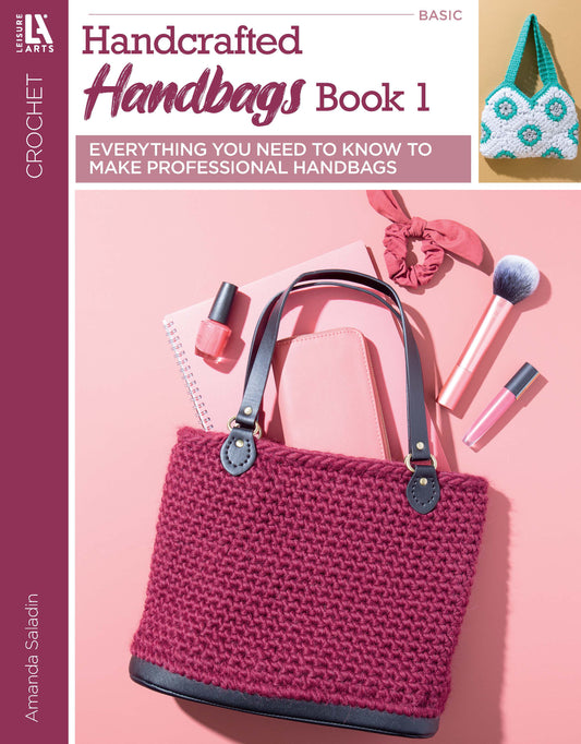 Leisure Arts’ Crochet Handcrafted Handbags Book 1 features beginner-friendly purse patterns, shown with a pink crochet bag, makeup, notebook, and mint-green bag on the cover. Learn to crochet stylish handbags with this guide.