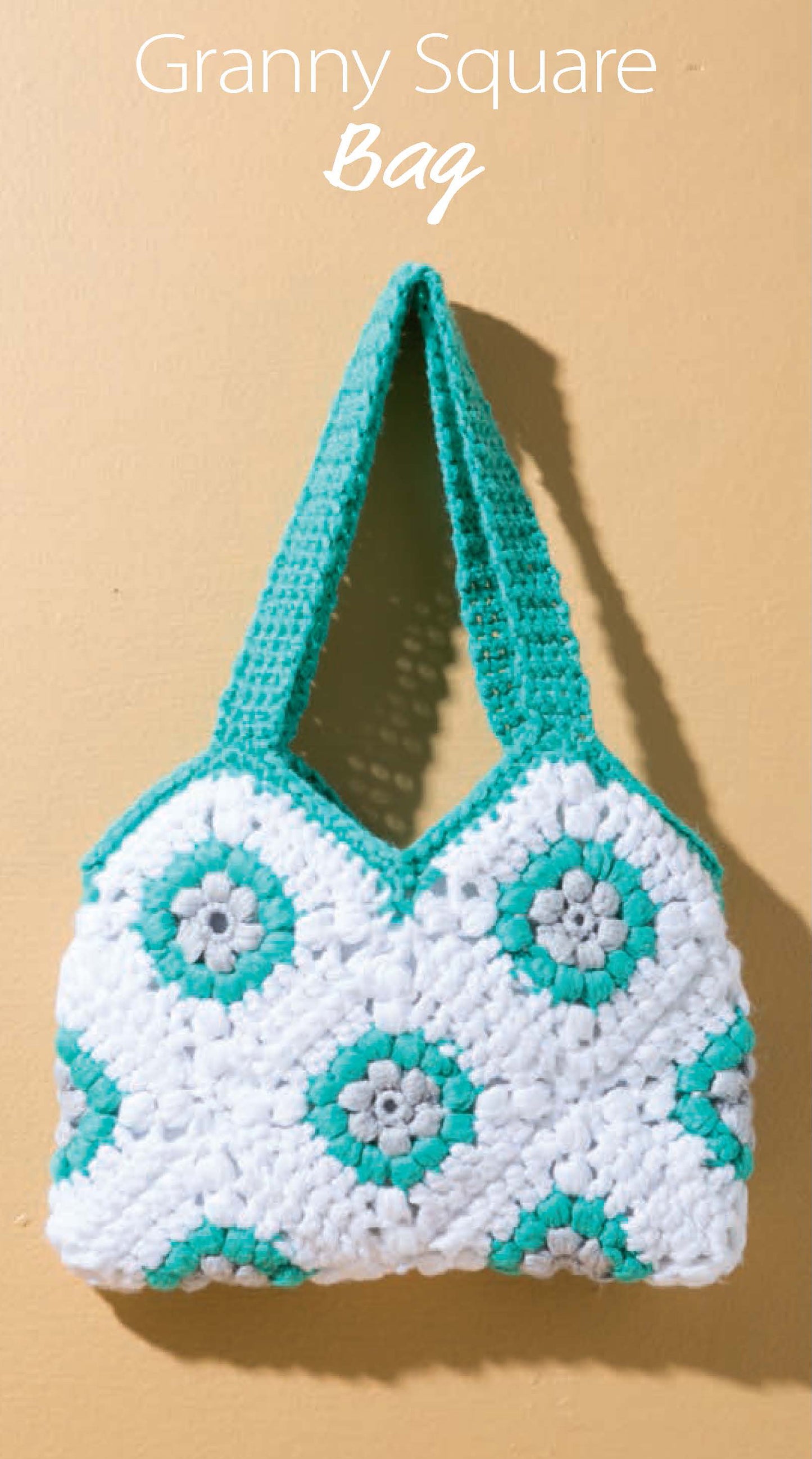 The image shows a crocheted granny square bag in white, turquoise, and gray with a turquoise handle on a beige wall. The text above reads "Granny Square Bag." Pattern from "Crochet Handcrafted Handbags Book 1" by Leisure Arts.