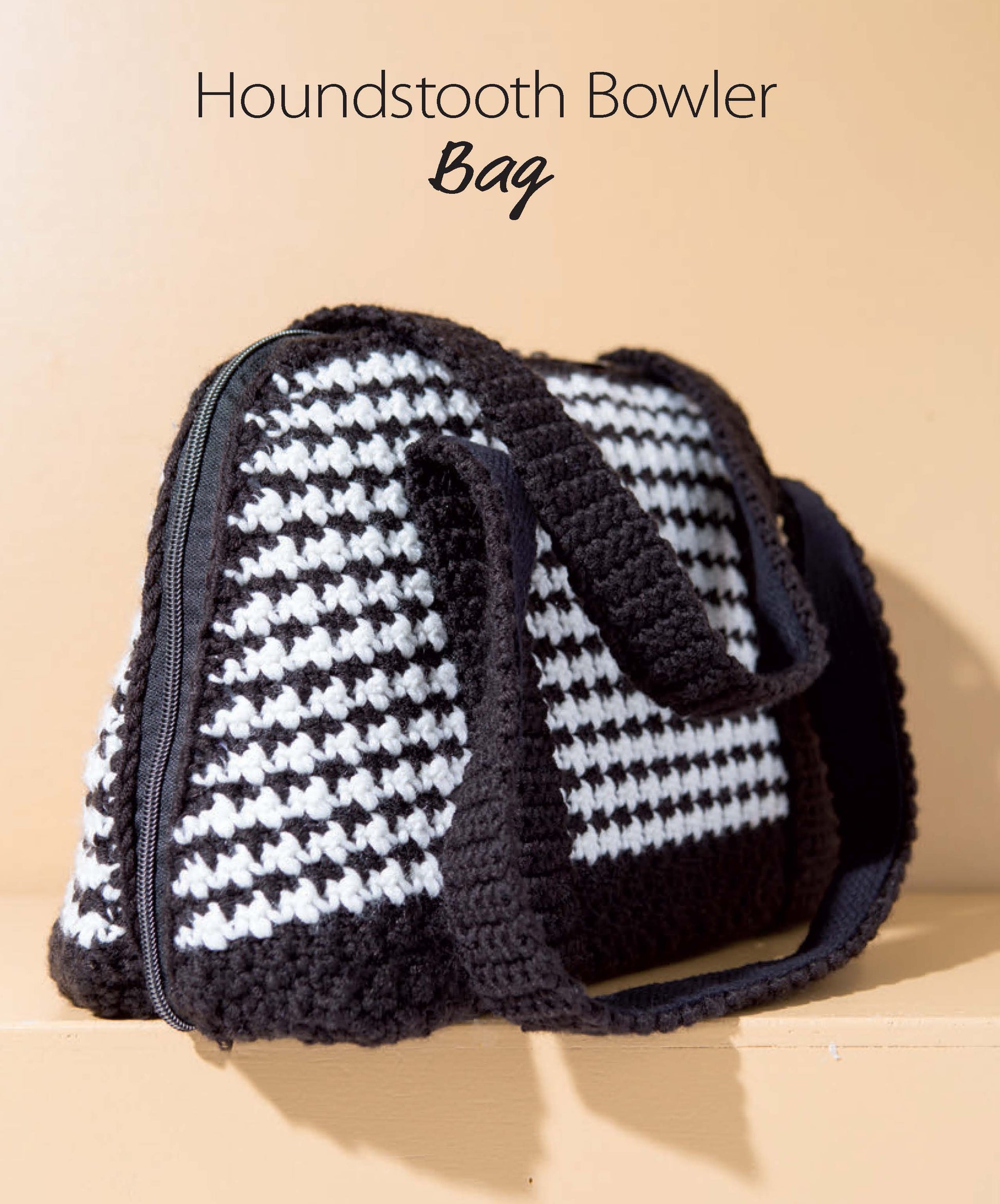 The "Crochet Handcrafted Handbags Book 4" by Leisure Arts features a black and white crocheted houndstooth bowler bag with black handles and a zipper, shown on a beige background and inspired by classic crochet bag patterns.